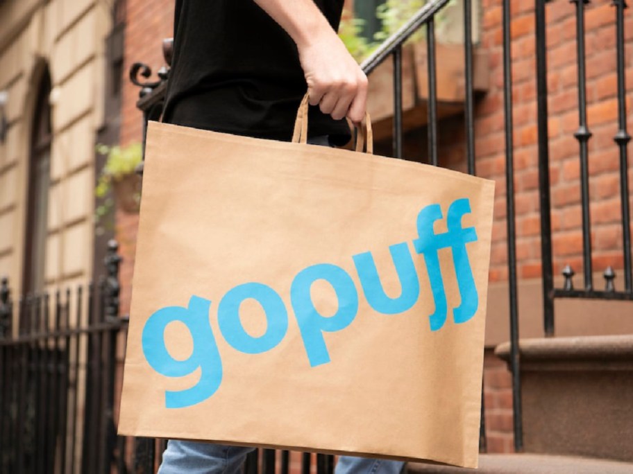 person carrying a gopuff bag