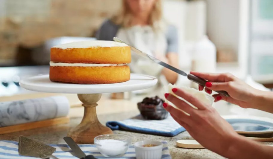 hands baking a cake