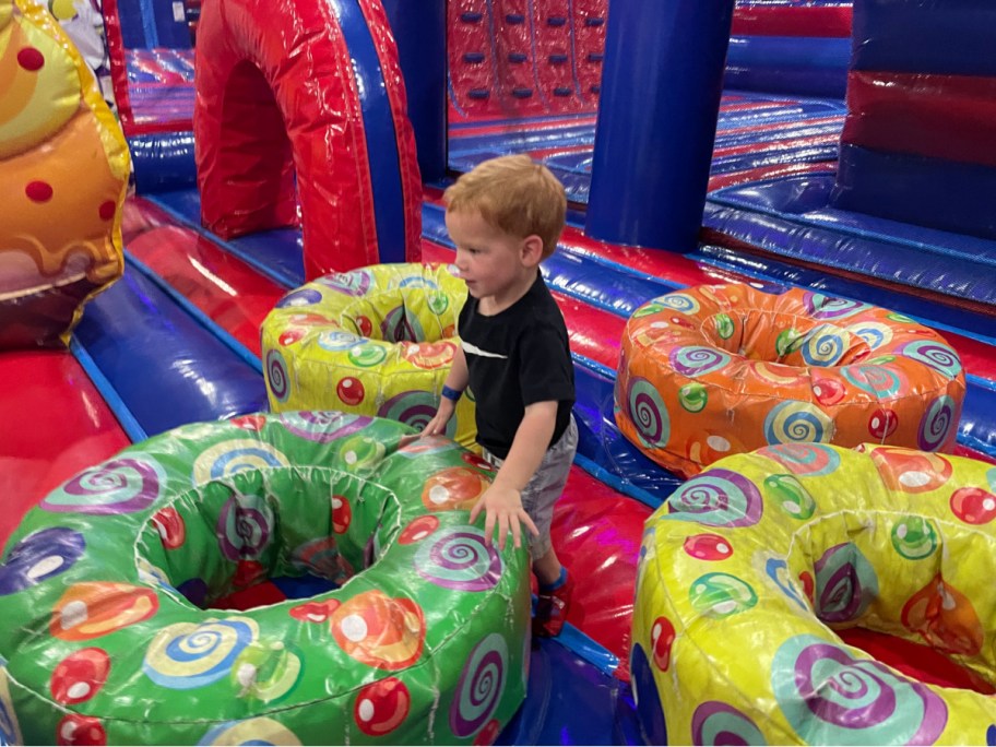 little boy in between inflatables