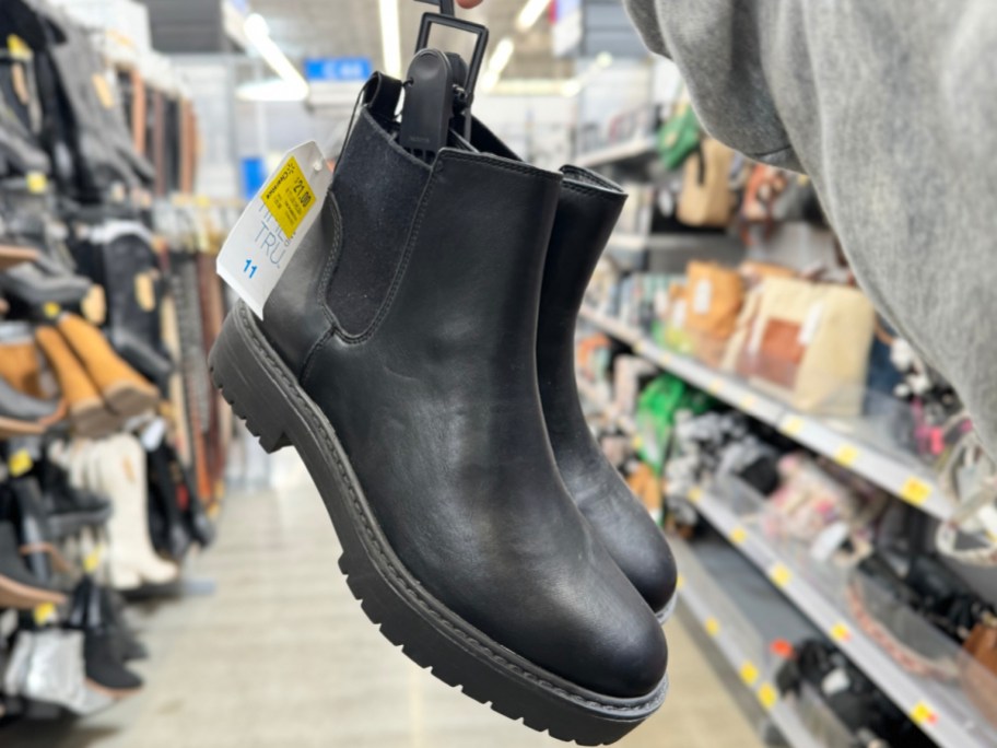 hand holding Time and Tru Women's Unit Chelsea Boots in store