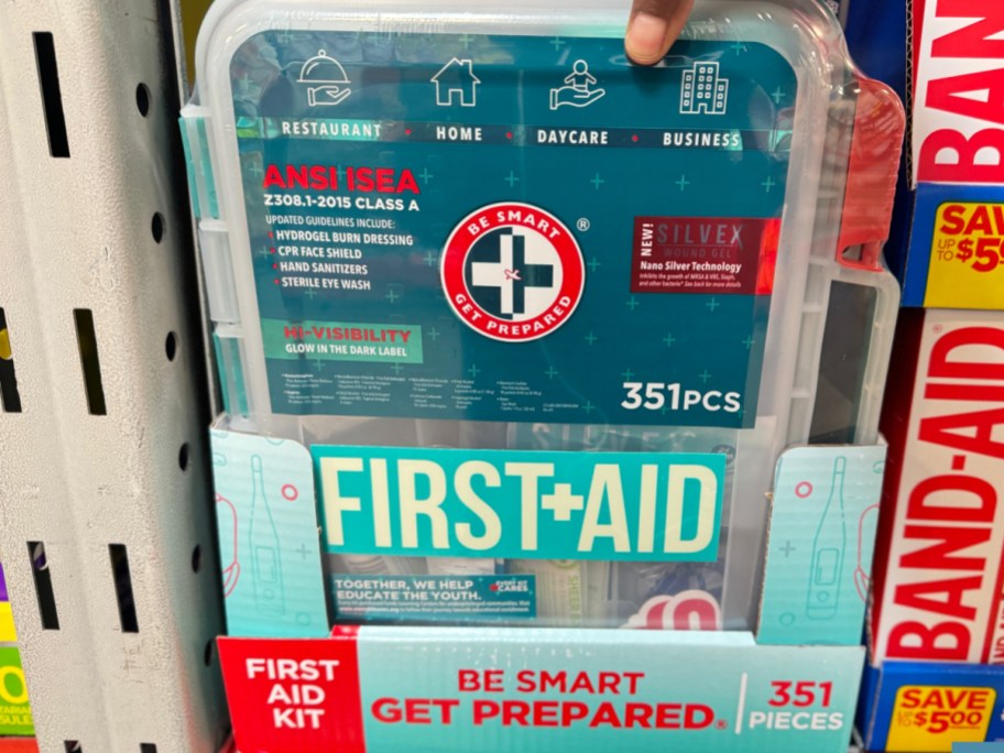 hand picking up the first aid kit at sams club with 351 pieces