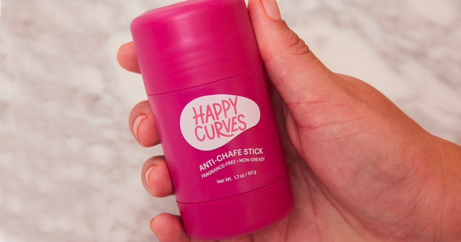 hand holding pink happy curves anti chafe stick