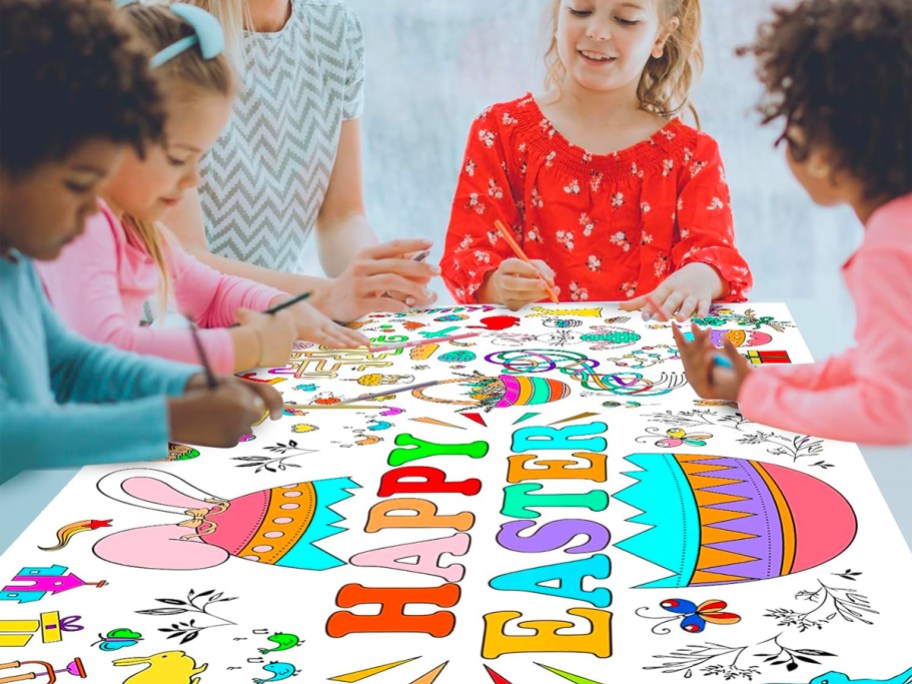 4 kids coloring on giant easter tablecloth