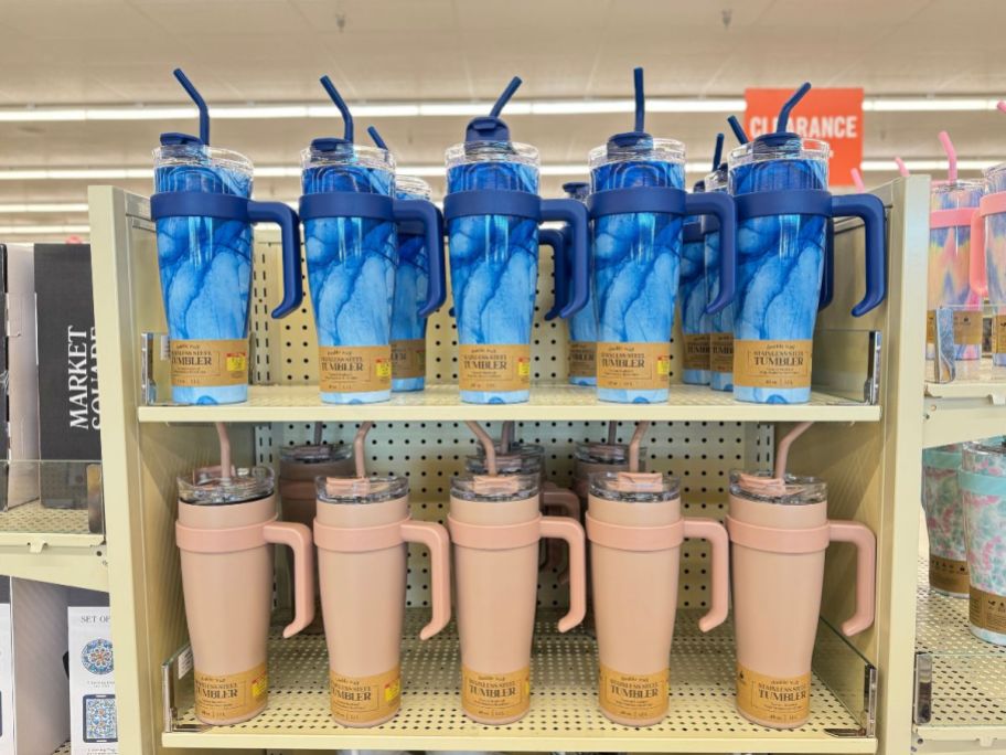 shelf with blue marble and tan color 40 oz stainless steel straw tumblers at Hobby Lobby