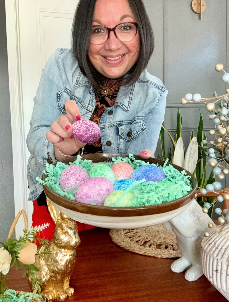 holding a plate of speckled easter eggs on a plate