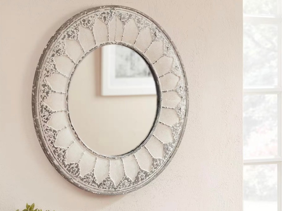 circle ivory mirror hanging on wall