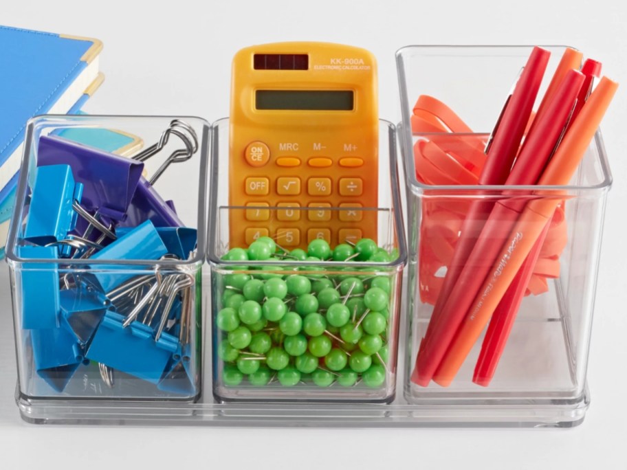 clear plastic office supply organizer bins with colorful office supplies in them