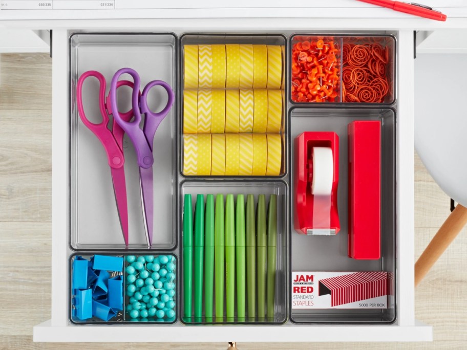 clear drawer organizer bins in a drawer with colorful office supplies in tehm
