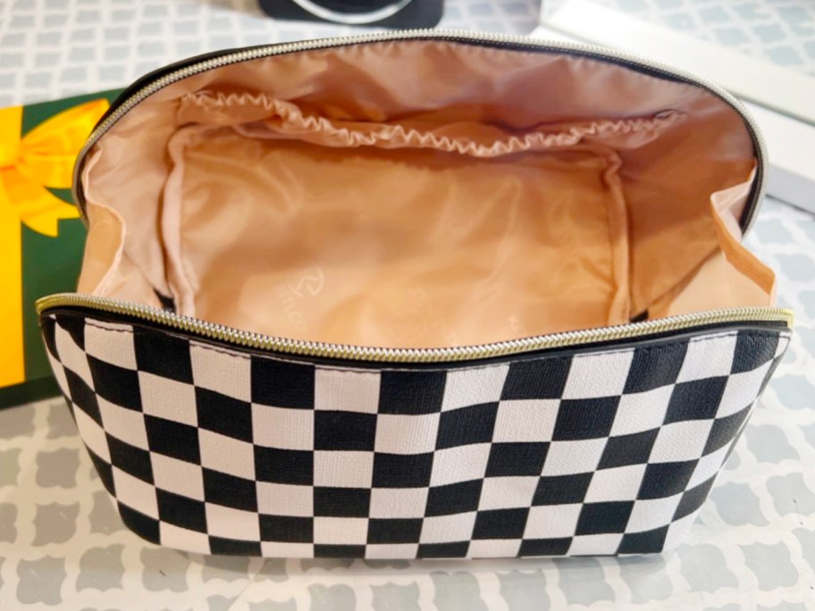 black and white checkered makeup bag open sitting on countertop