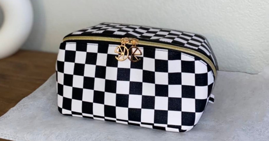 black and white checkered makeupbag sitting on countertop