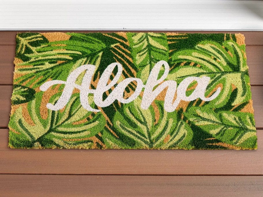 coir doormat with palm leaves that says "Aloha"