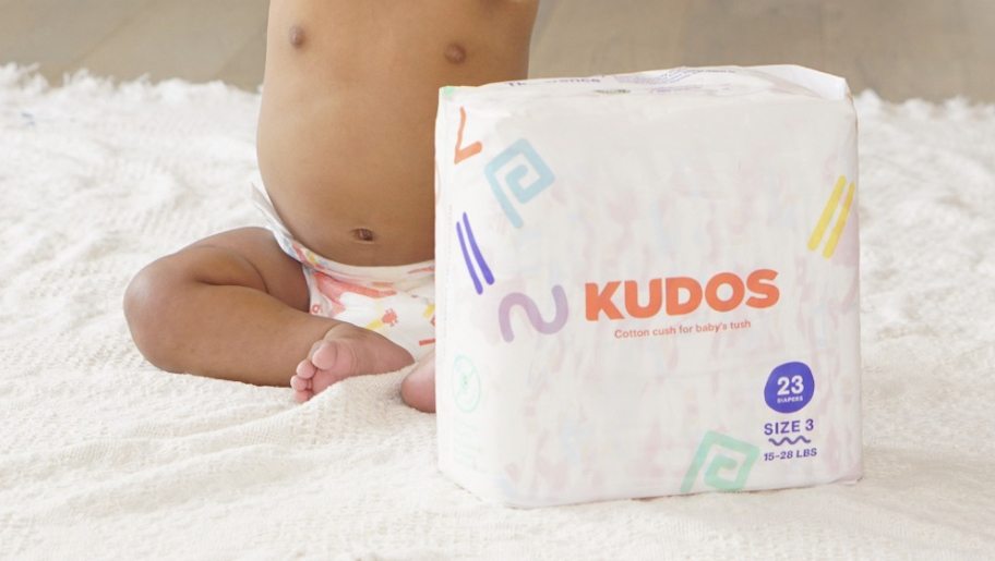 kudos diaper pack on bed next to baby in diaper