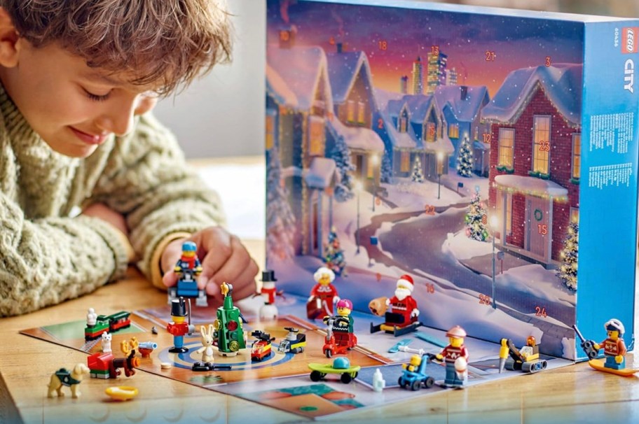 boy playing with lego city advent calendar pieces