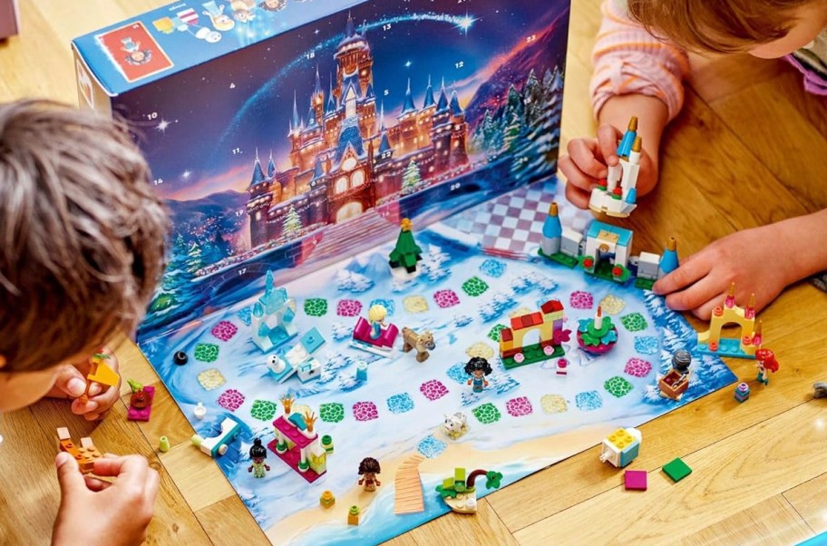 two kids playing with disney advent calendar