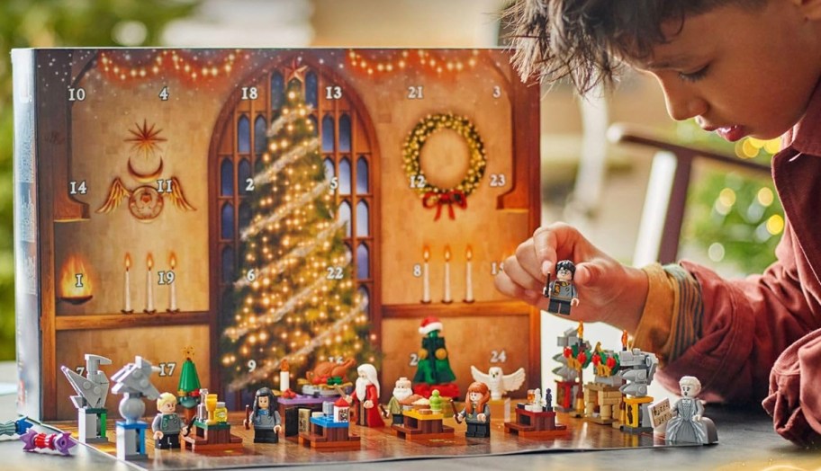 kid playing with lego harry potter advent calendar pieces 