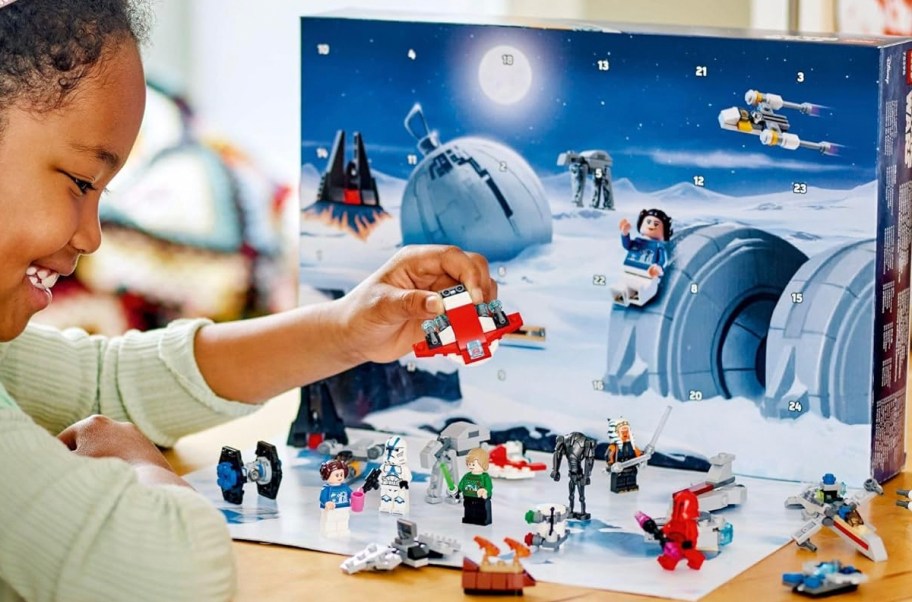 girl playing with lego star wars advent calendar pieces 