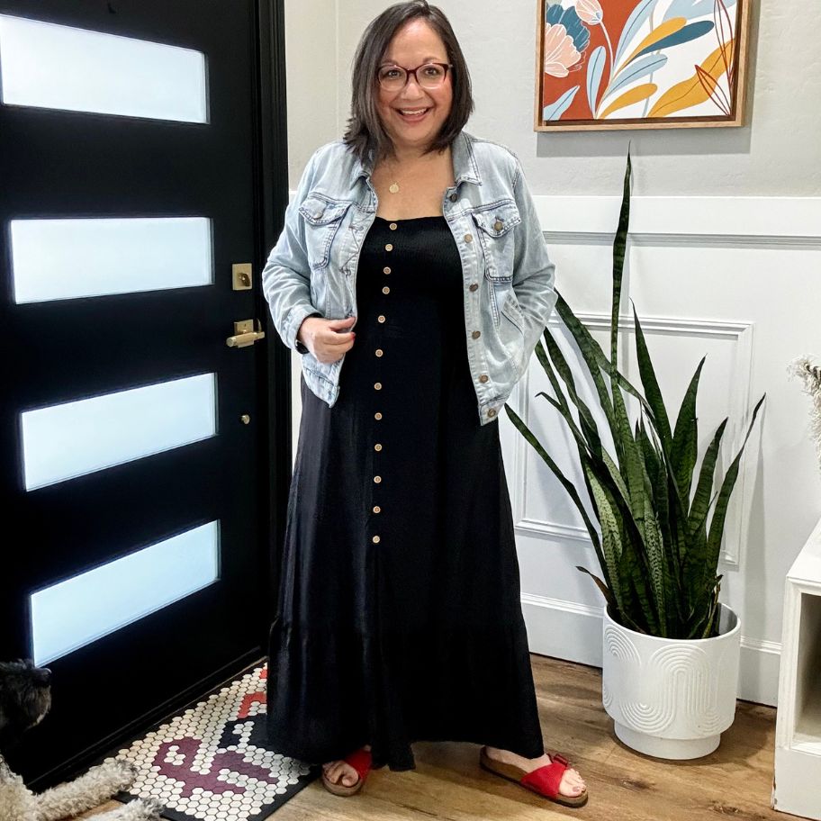 Lina waring a black women's sundress that has buttons down the front with a jean jacket
