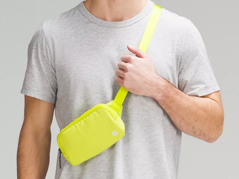 man wearing a yellow lululemon belt bag across his chest