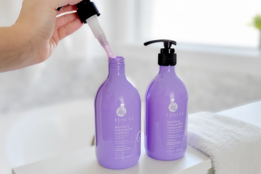 hand taking pump out of shampoo bottle