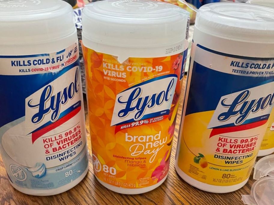 3 canisters of lysol wipes on a table