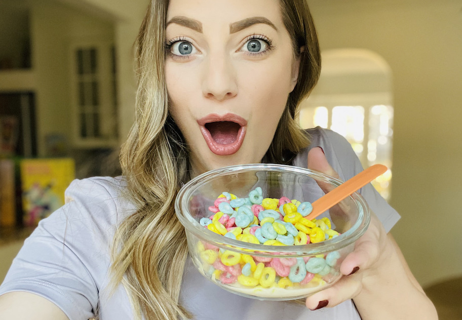 woman holding up bowl of colorful magic spoon cereal