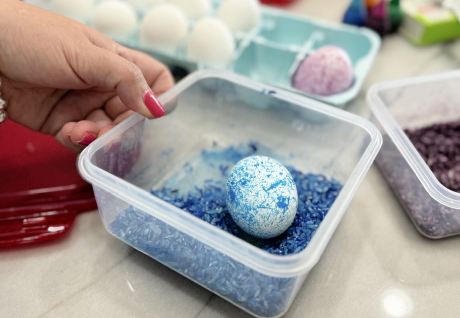 making a speckled easter egg with rice and blue food coloring