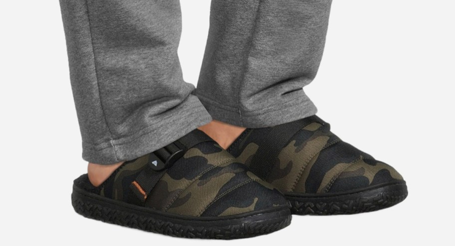 man wearing Walmart camo slippers with gray sweat pants