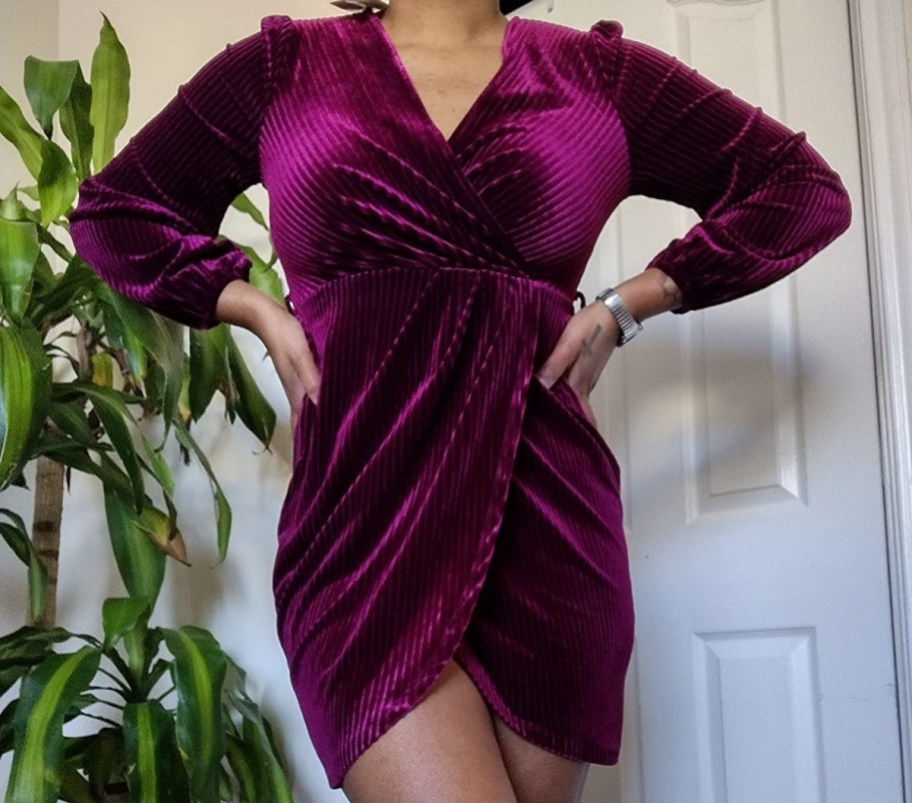 woman wearing burgundy velvet wrap dress