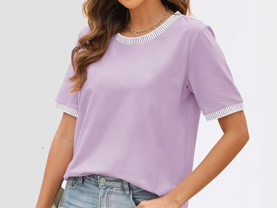 woman wearing purple tee and jeans