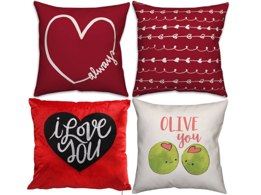 Four decorative pillows with love-themed designs: a heart outline saying "always," heart patterns, "I love you" text, and smiling olives with "Olive you."