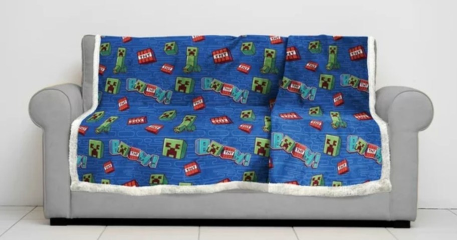 blue minecraft throw blanket laying on gray couch