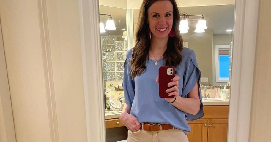 woman in blue shirt taking selfie