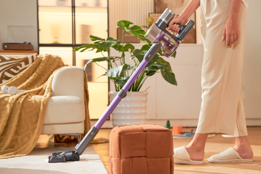 person cleaning with cordless vacuum