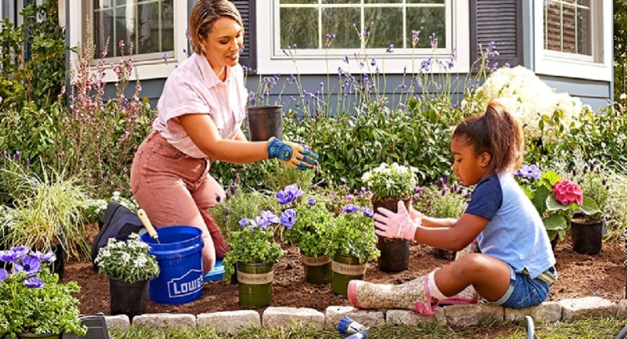 mom and daughter fixing their landscape with a Lowes bucket