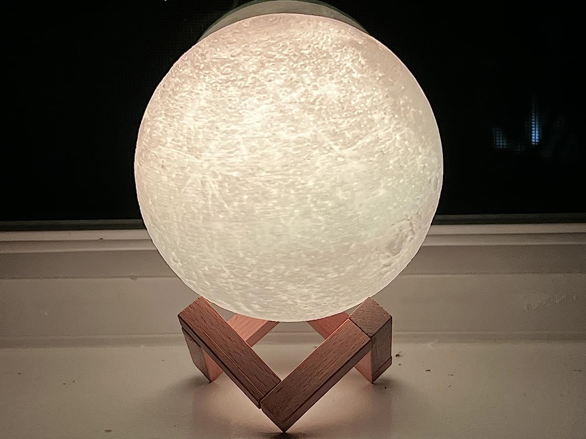 white moon lamp lit up sitting on table