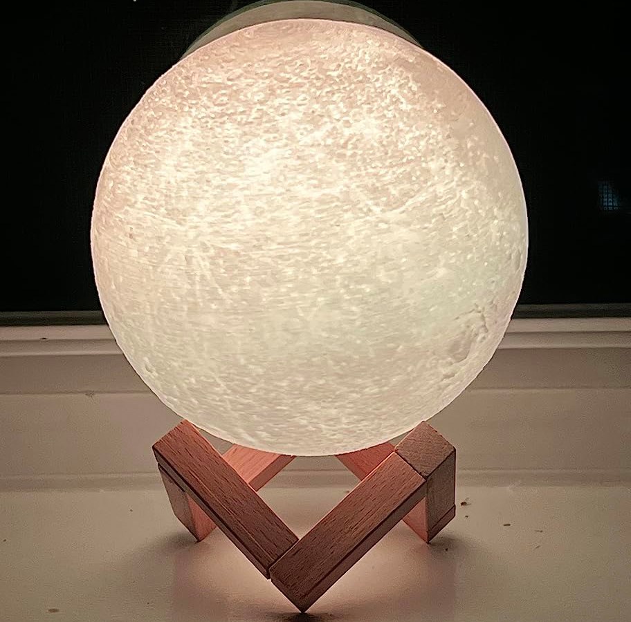 white moon lamp lit up sitting on table