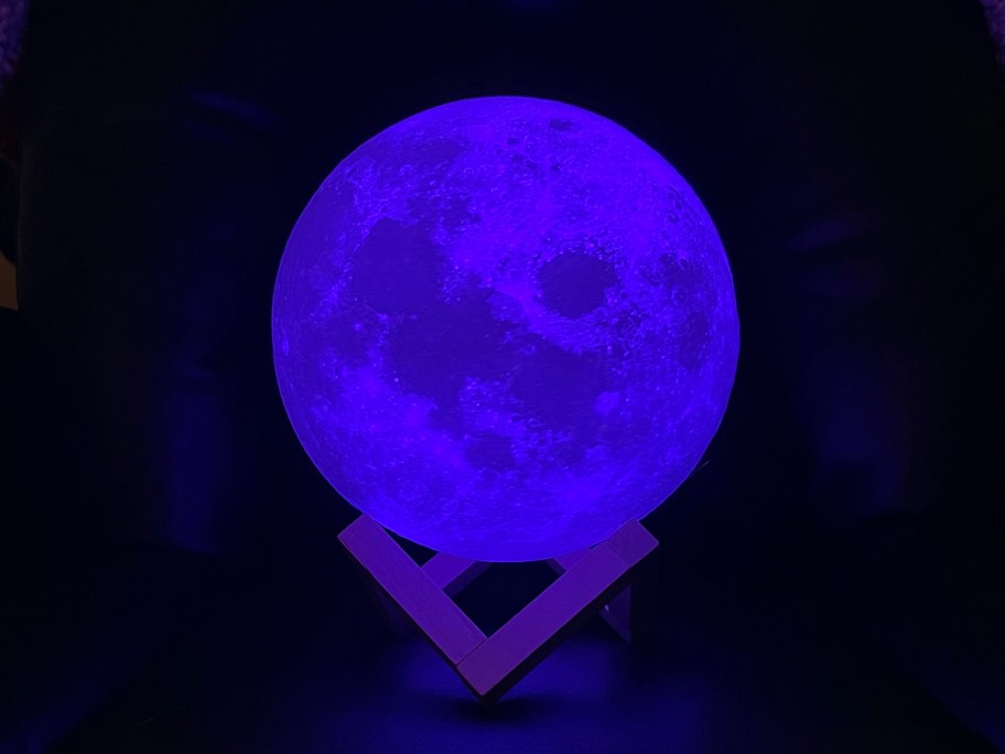 moon lamp lit up blue on stand