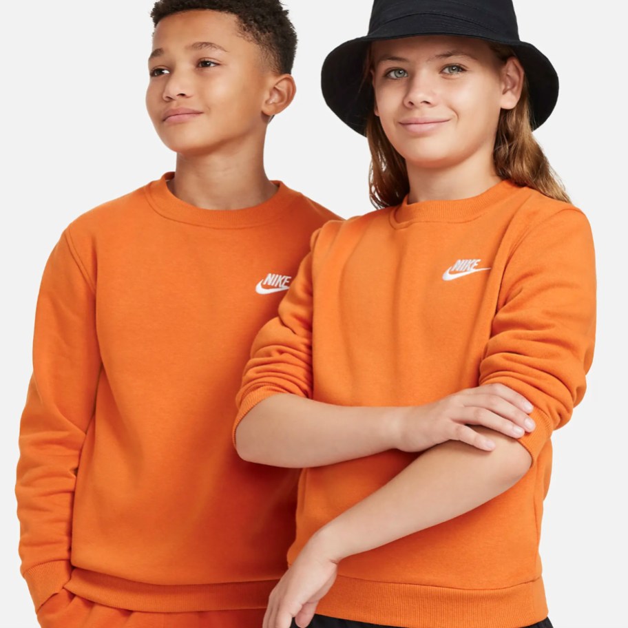 boy and girl wearing orange nike sweatshirt