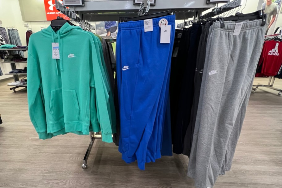 nike hoodie and joggers on hangers