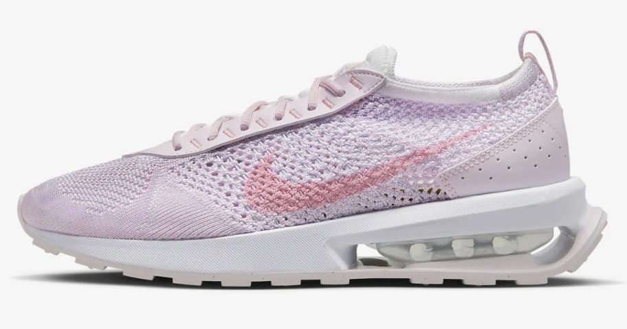 pink and white women's Nike running shoe