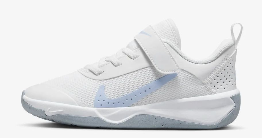 white Nike kid's shoes with blue swoosh and grey soles