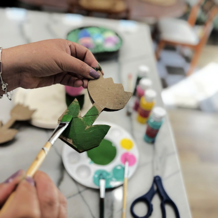 painting the stem of a cardboard tulip