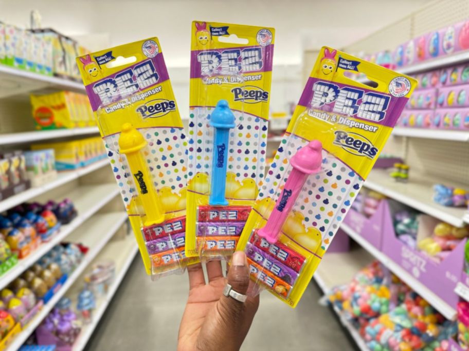 hand holding up 3 different color Peeps Chicks Pez Dispensers