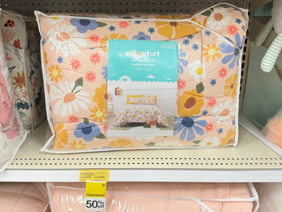 pink pillowfort comforter in bag on shelf in target store