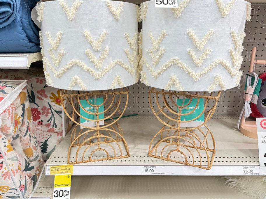 two boho rattan table lamps on shelf