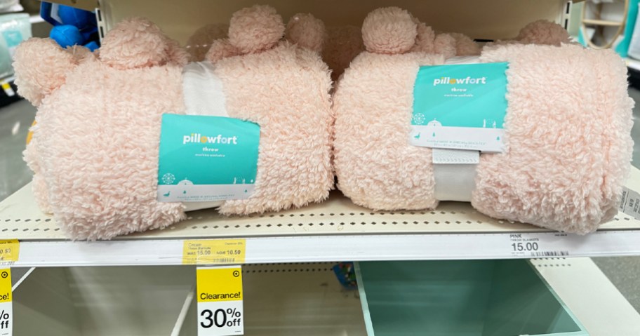 peach fluffy pillowfort blankets on shelf