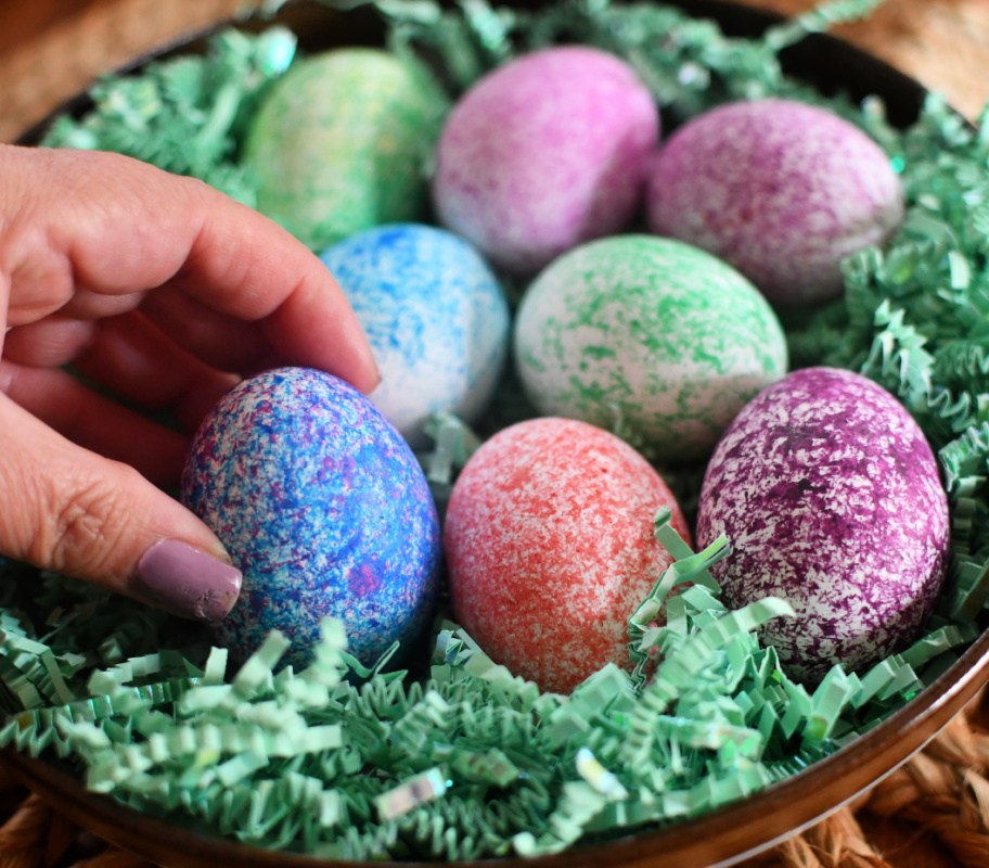 placing speckled eggs on a plate