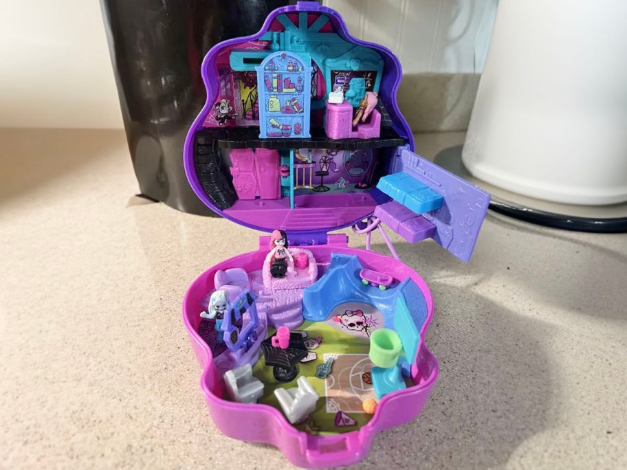 polly pocket monster high playset open on table 