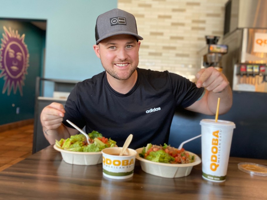 man showing off his Qdoba meals