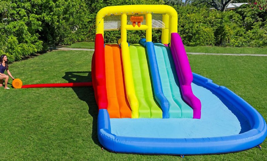 rainbow water park inflatable in someones backyard
